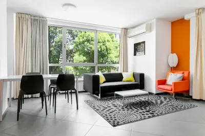 a living room with a table and chairs at Joy Apartment - Stylish 2BD in Oborishte by Flat Mаnager in Sofia