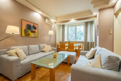 a living room with a couch and a table at Spacious and Central Retreat in Sofia