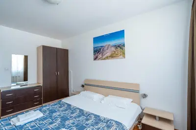 a hotel room with a bed and a television at Belvedere Bansko - Cozy 1BR - Ski in Winter, Swim in Summer! by Flat Mаnаger in Bansko