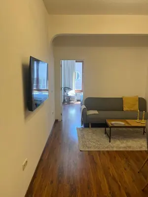 a living room with a couch and a tv at Dunav 11 in Sofia