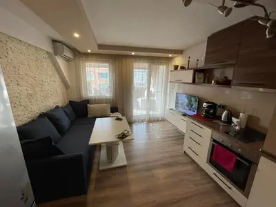 a living room with a blue couch and a table at Premium Nomad's Suite-Near Subway-Terrace in Sofia