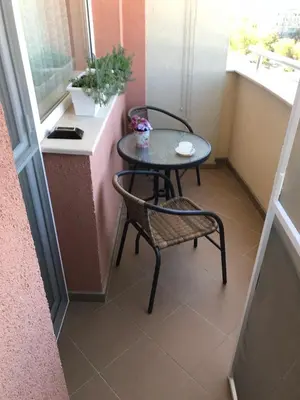 a small table and a chair in a small room at Premium High Rise, Gorgeous City Views in Plovdiv