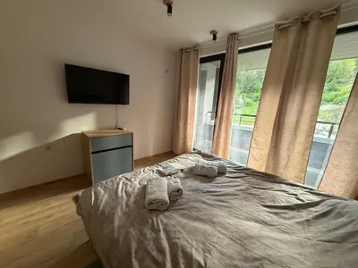 a bedroom with a bed with towels on it at Nikol5 Deluxe in Velingrad