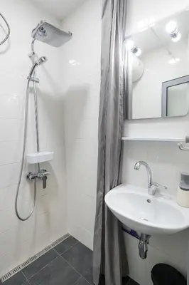 a white bathroom with a sink and a shower at Urban Oasis Heaven in Sofia