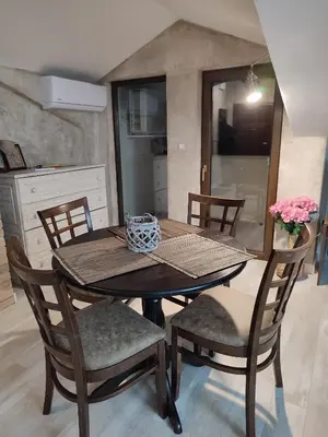 a dining room table and chairs in a kitchen at Топ локация! in Bansko