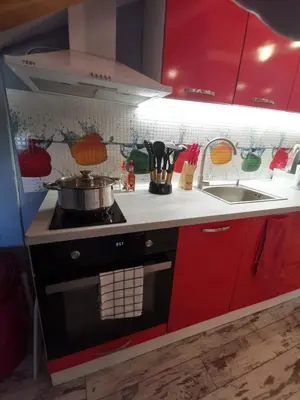 a kitchen with red cabinets and a stove top oven at D1 LOFT-Top center with free parking in Sofia