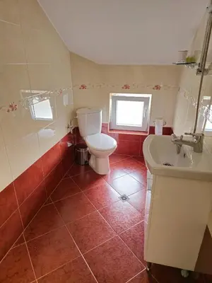 a bathroom with a toilet and a sink at Къща за гости Спирката 2 in Hotovo