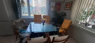 a dining room with a glass table and chairs at Къща за гости Спирката 2 in Hotovo