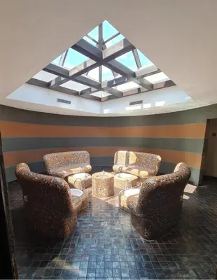 a living room with two chairs and a table at Trinity Apartment & Pool with Spa Near Center in Bansko