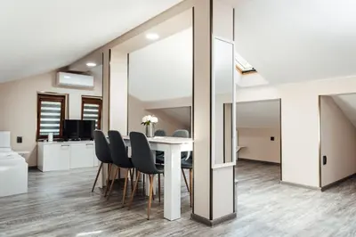 a dining room with a table and chairs and a mirror at Hrisi&Kris in Sapareva Banya