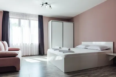 a bedroom with a large bed and a mirror at Hrisi&Kris in Sapareva Banya