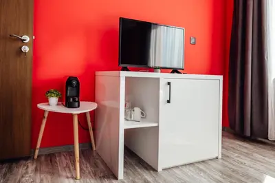 a white cabinet with a television on top of it at Hrisi&Kris in Sapareva Banya