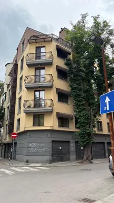 a yellow building with balconies on the side of it at Cosy apartment 11Mins Center in Plovdiv