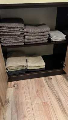 a group of folded towels sitting on a shelf at Cosy apartment 11Mins Center in Plovdiv