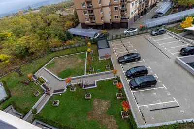 an aerial view of a parking lot with cars parked at Vitosha view Mladost apartment in Sofia