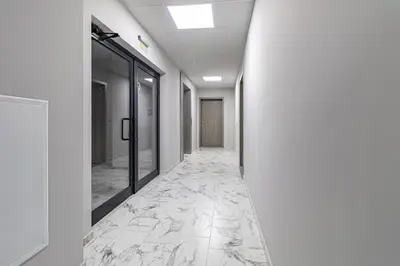 a corridor of an office with marble flooring at Vitosha view Mladost apartment in Sofia