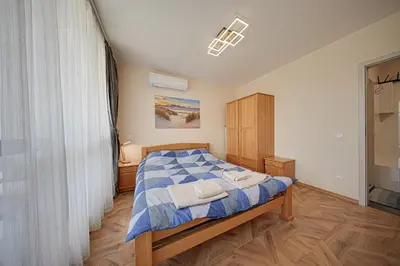 a bedroom with a bed with two towels on it at Brand New Vitosha View Apartment - Free Parking - Metro Access in Sofia