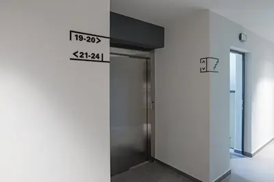 a elevator in a building with a sign on the wall at Brand New Vitosha View Apartment - Free Parking - Metro Access in Sofia