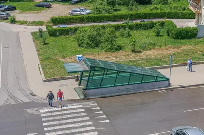 two people standing in front of a building on a street at Brand New Vitosha View Apartment - Free Parking - Metro Access in Sofia