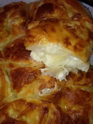 a close up of a pizza with cheese on it at Villa Dream in Dobrevtsi