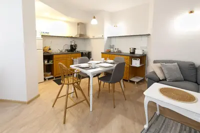 a kitchen and a living room with a table and chairs at MOD - Opera Plovdiv in Plovdiv