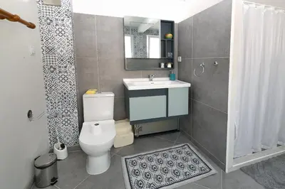 a bathroom with a toilet and a sink and a shower at MOD - Opera Plovdiv in Plovdiv