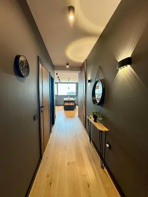 a hallway of a room with a table and a mirror at The Skyline Residence Sofia in Sofia