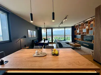 a large wooden table in a room with a living room at The Skyline Residence Sofia in Sofia