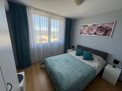 a bedroom with a bed and a window at Apartment 2-6 Royal Park in Bansko