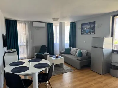 a living room with a table and a couch at Apartment 2-6 Royal Park in Bansko