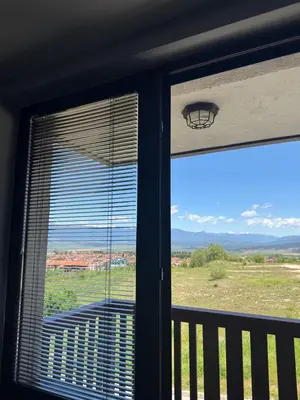 a window in a room with a view of a field at Apartment 2-6 Royal Park in Bansko