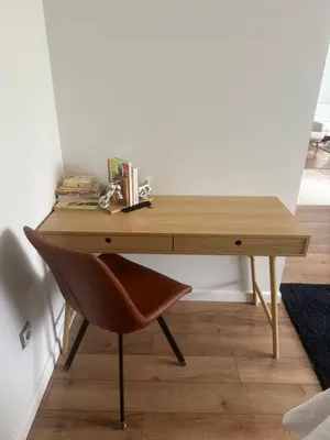a wooden desk with a chair next to a wall at Villa Green House in Tscherweni Breg