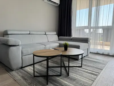 a living room with a couch and a table at 1BR Apartment with Panoramic View Balcony and Designated Parking Space in Plovdiv