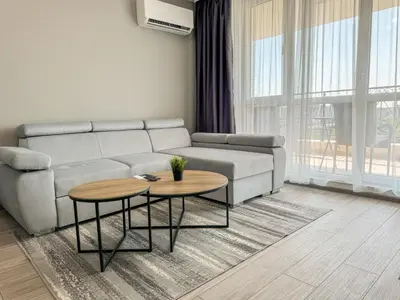 a living room with a couch and two tables at 1BR Apartment with Panoramic View Balcony and Designated Parking Space in Plovdiv