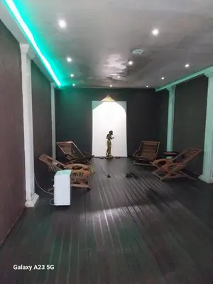 a room with a person standing in a room with chairs at Aпартамент за гости SKI DREAM Grand Monastery-Пампорово in Pamporovo