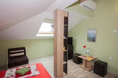 a small attic room with a bed and a mirror at SimplyComfy in Plovdiv