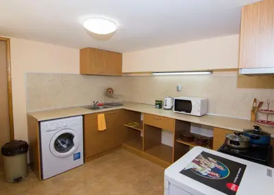 a kitchen with a washing machine and a microwave at SimplyComfy in Plovdiv
