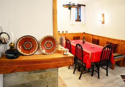 a dining room with a table with plates on it at SimplyComfy in Plovdiv