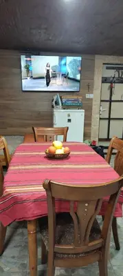 a dining room table with a plate of fruit on it at Villa Byala Luna - Guest House in Bistriza