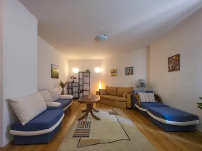 a living room with blue couches and a table at Charming 1BD Flat at Edelweiss Inn, Bansko by Flat Mаnager in Bansko