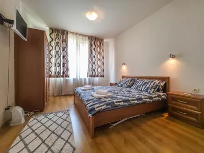 a small bedroom with a bed and a window at Charming 1BD Flat at Edelweiss Inn, Bansko by Flat Mаnager in Bansko