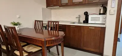 a kitchen with a table and chairs and a microwave at Gondola luxury apartment 2 in Bansko