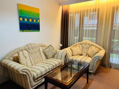 a living room with two couches and a coffee table at Gondola luxury apartment 2 in Bansko