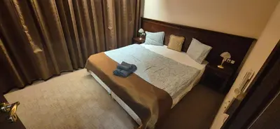 a bedroom with a large bed with a blue cross on it at Gondola luxury apartment 1 in Bansko