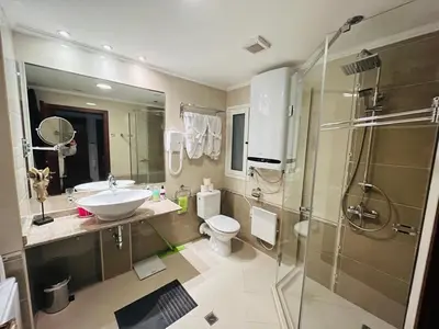 a bathroom with a sink and a toilet and a shower at Gondola luxury apartment 1 in Bansko