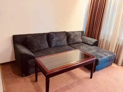 a black couch with a coffee table in a living room at Gondola luxury apartment 1 in Bansko