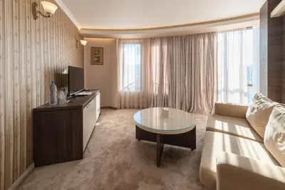 a living room with a couch and a table at Mantar Spa Hotel in Marikostinovo