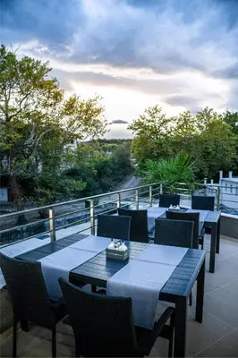 a patio with tables and chairs on a balcony at SIBIYA Hotel in Ognyanovo