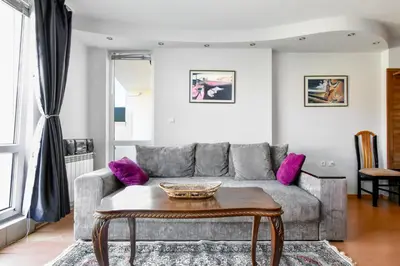 a living room with a couch and a table at Stylish 1BD Apt in Lozenets with large balcony by Flat Manager in Sofia