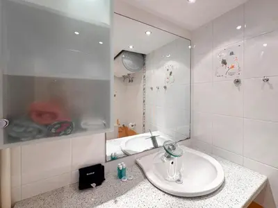 a white bathroom with a sink and a mirror at Stylish 1BD Apt in Lozenets with large balcony by Flat Manager in Sofia